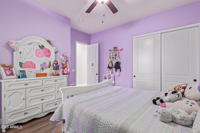 bedroom featuring a closet, dark wood-type flooring, and a ceiling fan
