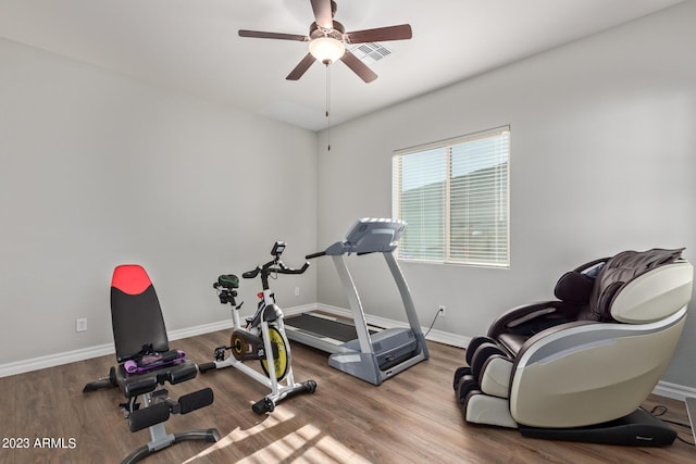workout area with visible vents, baseboards, ceiling fan, and wood finished floors