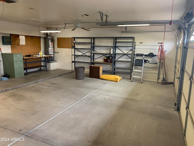 garage with a workshop area, ceiling fan, and gas water heater