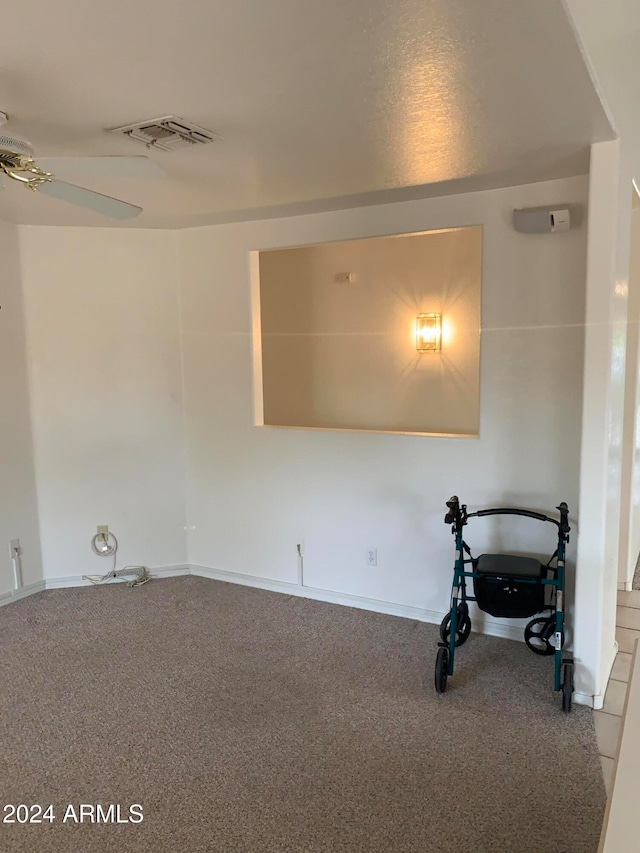 spare room featuring ceiling fan and carpet flooring