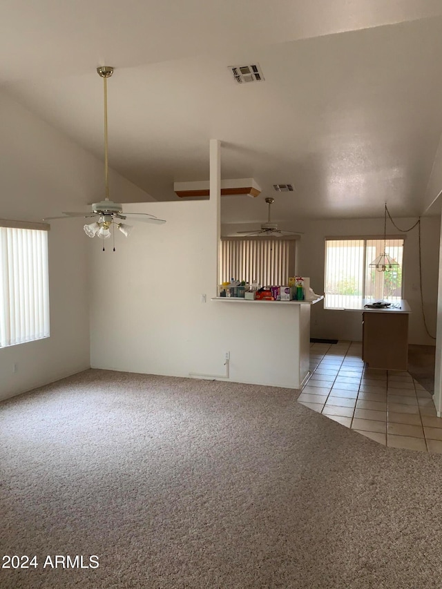 unfurnished living room featuring lofted ceiling, tile patterned flooring, and ceiling fan