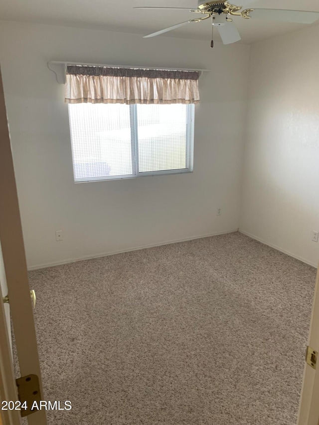 empty room featuring carpet flooring and ceiling fan