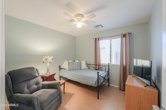 bedroom with ceiling fan and light tile patterned floors