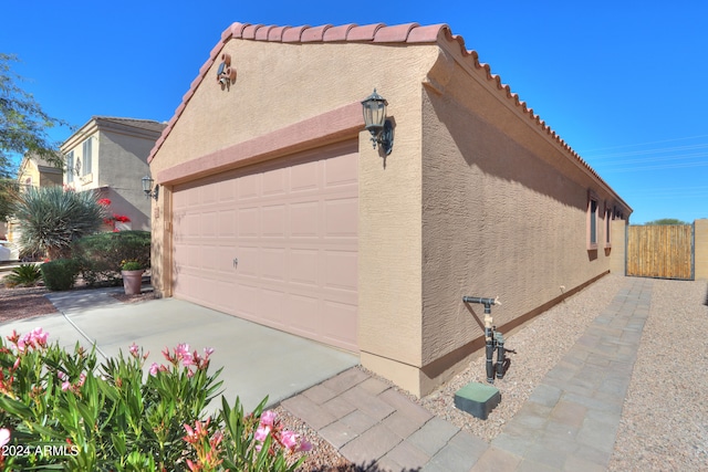 view of side of property with a garage