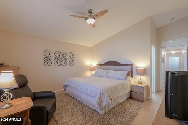 tiled bedroom with ceiling fan and high vaulted ceiling