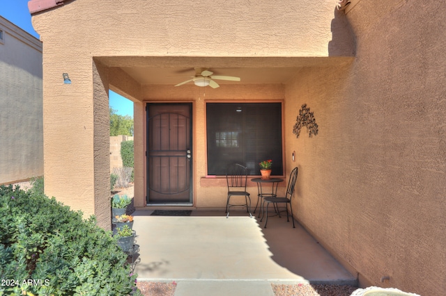 entrance to property with ceiling fan