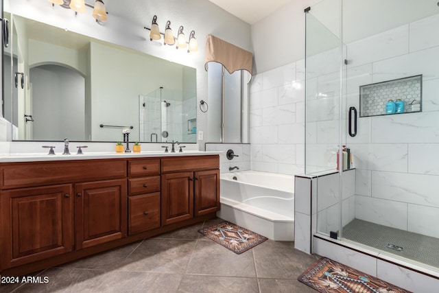 bathroom featuring tile patterned floors, vanity, and shower with separate bathtub