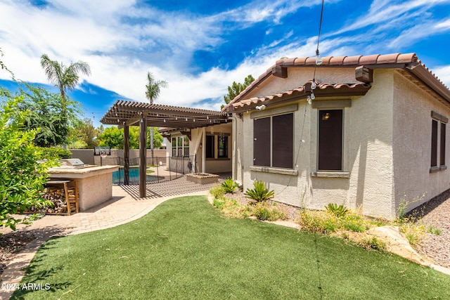 rear view of property with a patio area, a yard, a pergola, area for grilling, and a bar