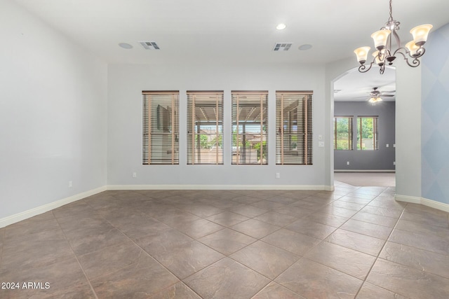 unfurnished room with tile patterned floors and ceiling fan with notable chandelier