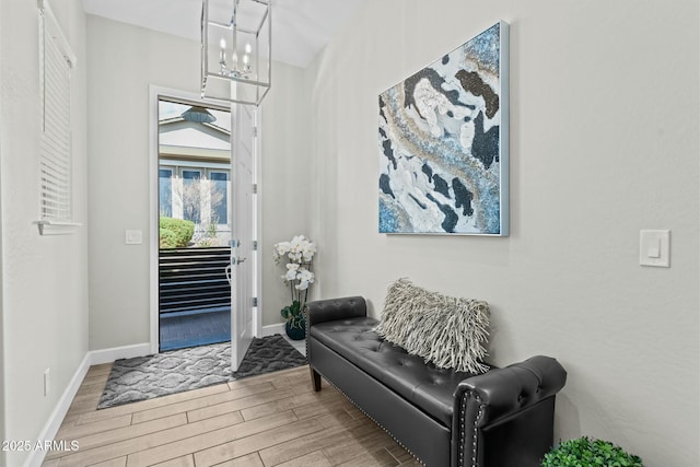 foyer featuring baseboards and wood finished floors