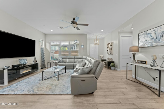 living area featuring recessed lighting, visible vents, baseboards, a ceiling fan, and wood tiled floor