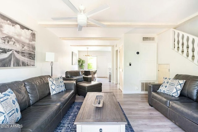 living room featuring hardwood / wood-style floors, beamed ceiling, and ceiling fan