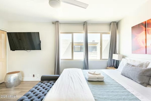 bedroom featuring multiple windows and light hardwood / wood-style floors