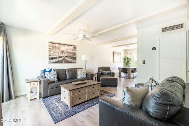 living room with ceiling fan, beam ceiling, and light hardwood / wood-style flooring