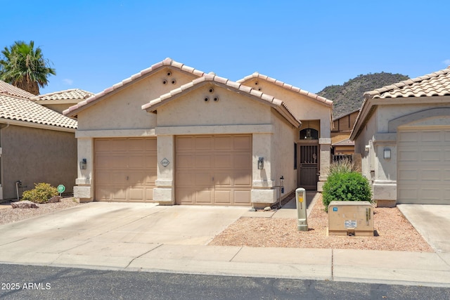 4918 W Wahalla Ln, Glendale, AZ 85308 - mediterranean / spanish-style house featuring an attached garage, driveway, stucco siding, and a tile roof