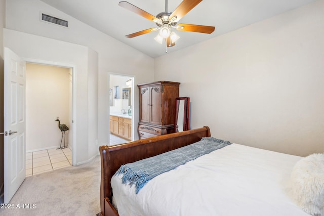 4918 W Wahalla Ln, Glendale, AZ 85308 - bedroom with vaulted ceiling, light colored carpet, light tile patterned floors, ensuite bath, and ceiling fan