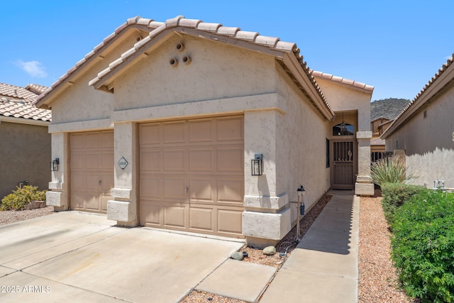 4918 W Wahalla Ln, Glendale, AZ 85308 - view of front of house with stucco siding, a tile roof, a garage, and driveway