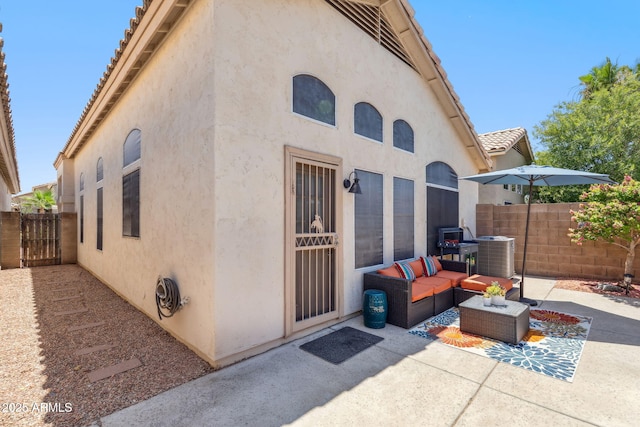 4918 W Wahalla Ln, Glendale, AZ 85308 - doorway to property featuring stucco siding, a patio, and outdoor lounge area