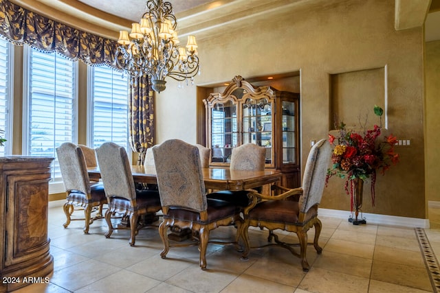 dining space with a chandelier and light tile patterned floors