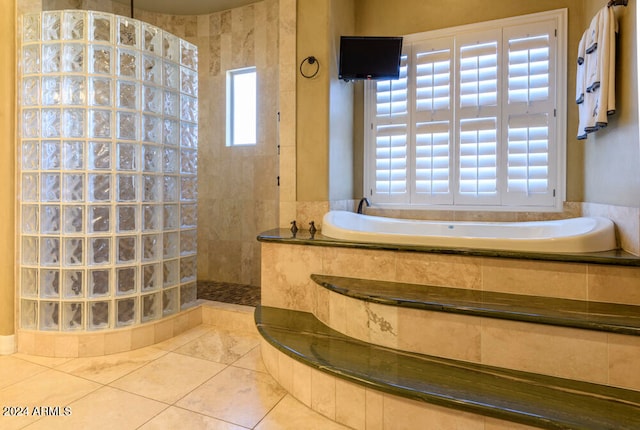 bathroom featuring tile patterned flooring and a tile shower