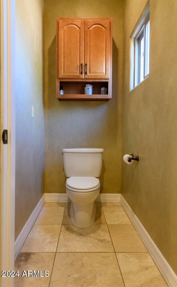 bathroom featuring tile patterned floors and toilet