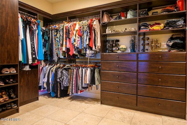 spacious closet featuring light tile patterned floors