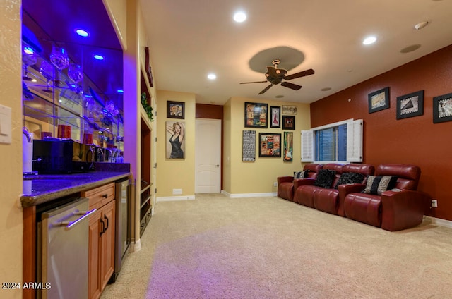 cinema room featuring ceiling fan, light carpet, wine cooler, and bar area