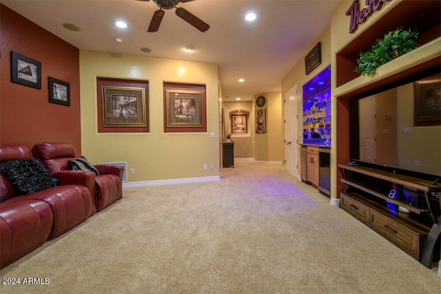 carpeted home theater room with ceiling fan