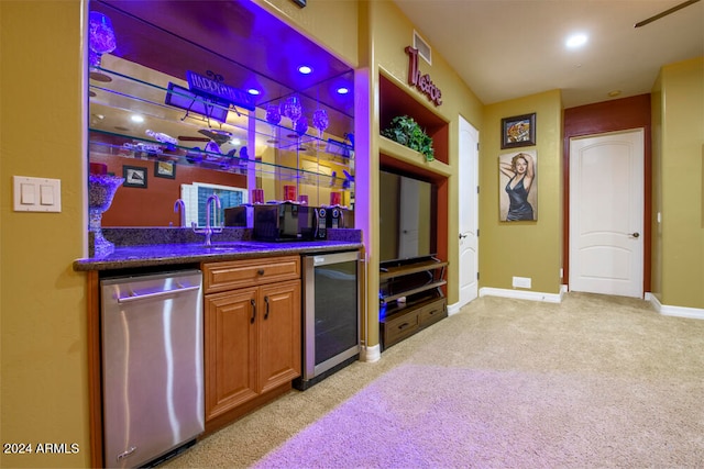 bar featuring dishwasher, light colored carpet, dark stone countertops, and beverage cooler