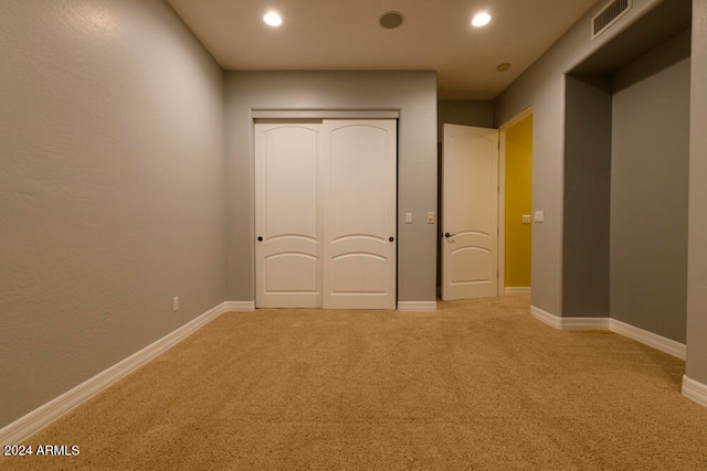 unfurnished bedroom with carpet flooring and a closet