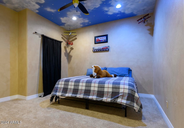 bedroom featuring ceiling fan and carpet