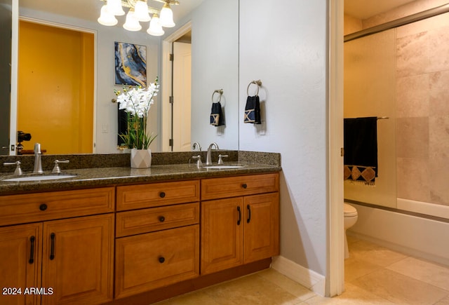 full bathroom with tile patterned floors, vanity, bath / shower combo with glass door, and toilet