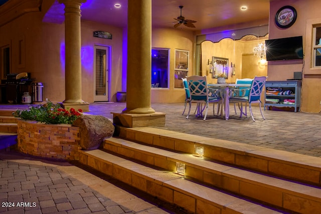 exterior space with ceiling fan and decorative columns