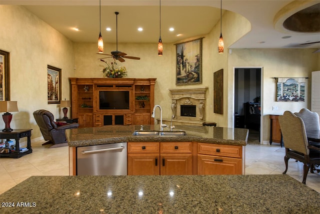 kitchen with dishwasher, sink, hanging light fixtures, ceiling fan, and an island with sink