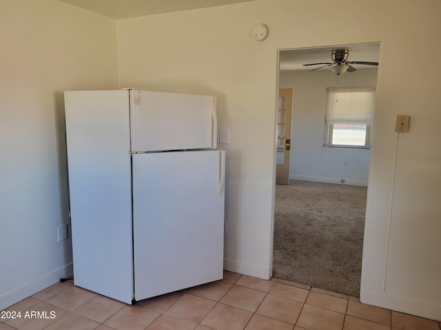 kitchen featuring ceiling fan, light carpet, and white refrigerator