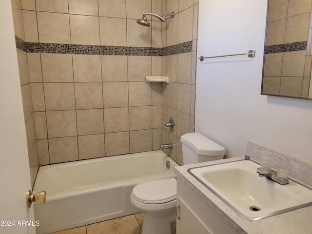full bathroom with toilet, vanity, tiled shower / bath, and tile patterned floors