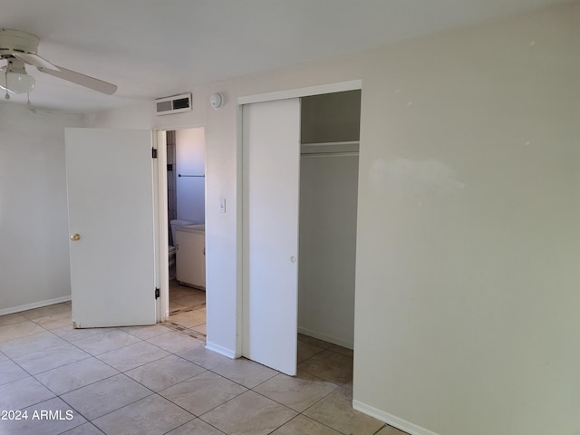 unfurnished bedroom featuring light tile patterned floors, ceiling fan, and a closet