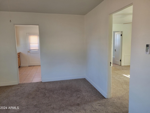 spare room featuring light colored carpet