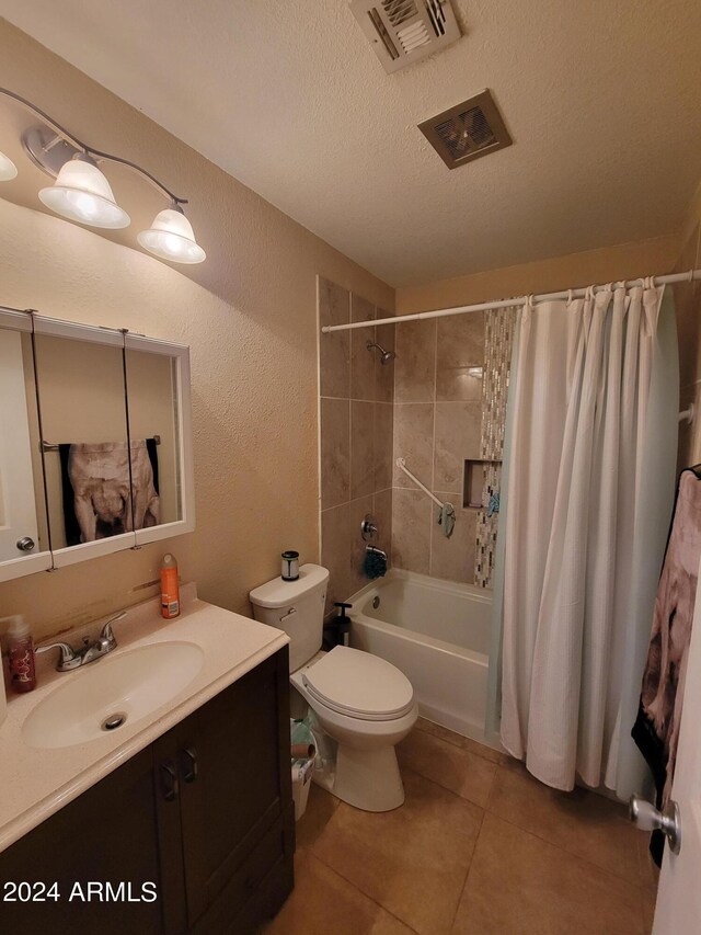 full bathroom featuring vanity, shower / bath combination with curtain, toilet, a textured ceiling, and tile patterned flooring