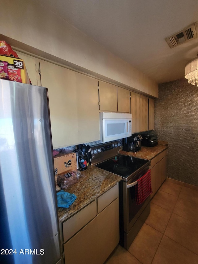 kitchen featuring appliances with stainless steel finishes and light tile patterned floors