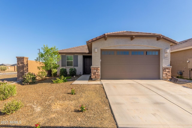 12505 W Kaler Dr, Glendale, AZ 85307 - view of front of home featuring a tiled roof, an attached garage, concrete driveway, stucco siding, and stone siding