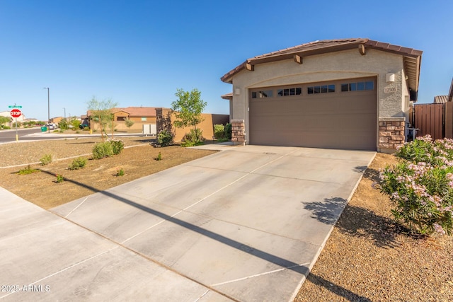 12505 W Kaler Dr, Glendale, AZ 85307 - mediterranean / spanish house with stone siding, stucco siding, concrete driveway, a tiled roof, and an attached garage
