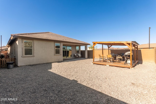 12505 W Kaler Dr, Glendale, AZ 85307 - rear view of house with a fenced backyard, a wooden deck, a tile roof, and stucco siding