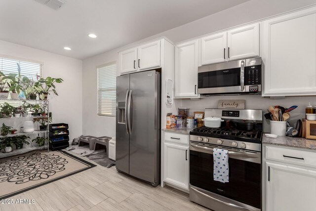 12505 W Kaler Dr, Glendale, AZ 85307 - kitchen featuring stainless steel appliances, white cabinetry, light stone counters, and recessed lighting