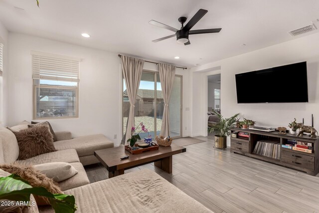 12505 W Kaler Dr, Glendale, AZ 85307 - living room with ceiling fan, recessed lighting, light wood-style flooring, and baseboards