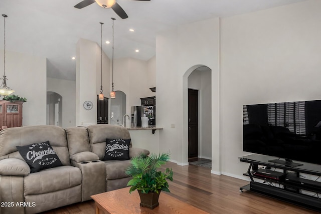 23813 S Pleasant Way, Sun Lakes, AZ 85248 - living room featuring baseboards, arched walkways, a ceiling fan, and wood finished floors