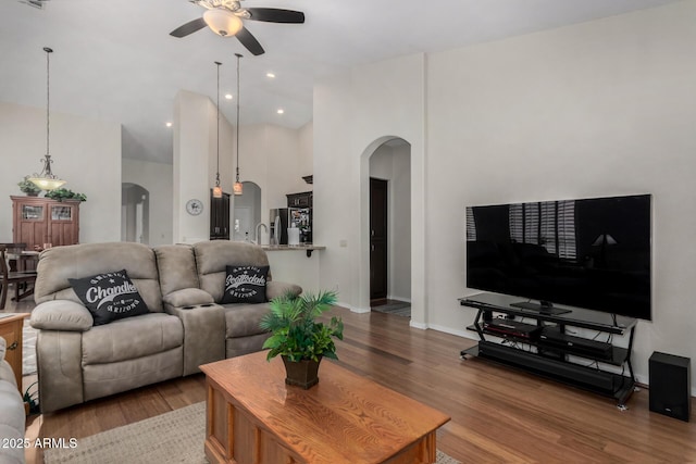 23813 S Pleasant Way, Sun Lakes, AZ 85248 - living room with arched walkways, light wood finished floors, and a ceiling fan