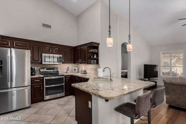 23813 S Pleasant Way, Sun Lakes, AZ 85248 - kitchen with visible vents, a sink, appliances with stainless steel finishes, and high vaulted ceiling