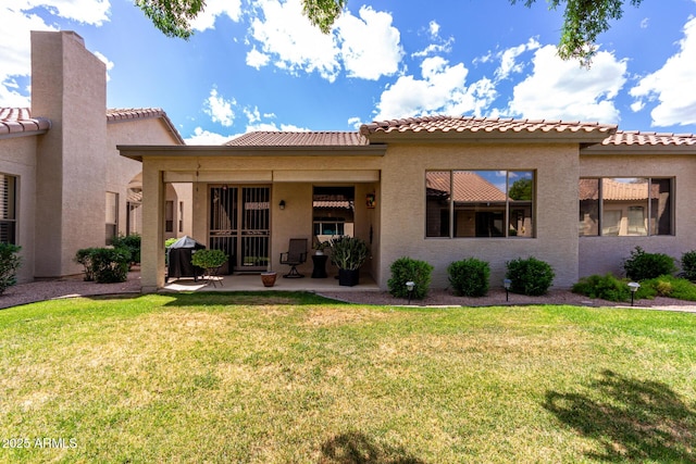 23813 S Pleasant Way, Sun Lakes, AZ 85248 - rear view of property with a yard, stucco siding, and a tiled roof