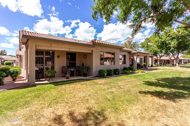 23813 S Pleasant Way, Sun Lakes, AZ 85248 - back of property with a tiled roof, a lawn, a patio area, and stucco siding